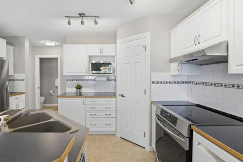 34 Arbour Stone Rise Nw, Calgary, AB - Indoor Photo Showing Kitchen With Double Sink