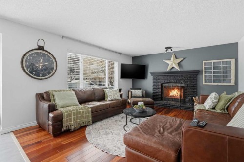 123 Schubert Hill Nw, Calgary, AB - Indoor Photo Showing Living Room With Fireplace