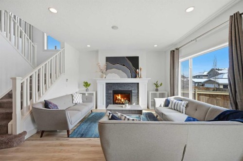 1153 Kingston Crescent Se, Airdrie, AB - Indoor Photo Showing Living Room With Fireplace