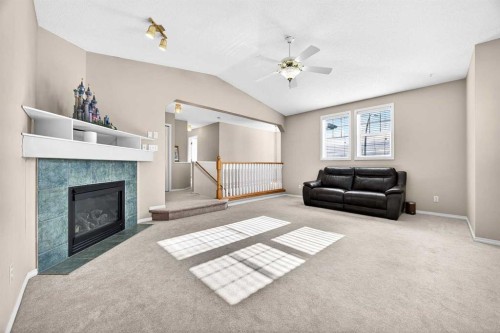 287 Panamount Drive Nw, Calgary, AB - Indoor Photo Showing Living Room With Fireplace