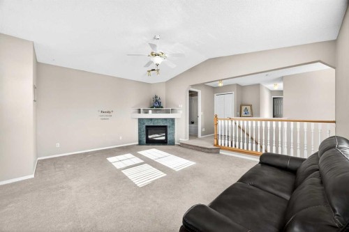 287 Panamount Drive Nw, Calgary, AB - Indoor Photo Showing Living Room With Fireplace