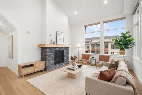 402-1505 Spring Creek Gate, Canmore, AB - Indoor Photo Showing Living Room With Fireplace