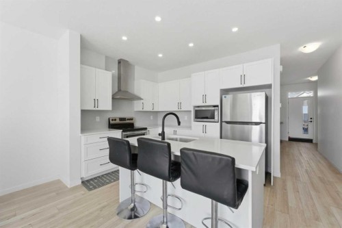 233 Copperleaf Way Se, Calgary, AB - Indoor Photo Showing Kitchen With Stainless Steel Kitchen With Upgraded Kitchen