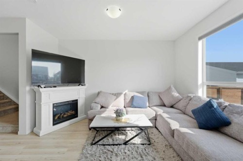233 Copperleaf Way Se, Calgary, AB - Indoor Photo Showing Living Room With Fireplace