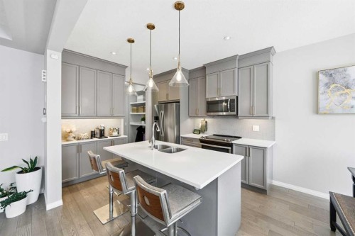 134 Windrow Link Sw, Airdrie, AB - Indoor Photo Showing Kitchen With Stainless Steel Kitchen With Double Sink With Upgraded Kitchen