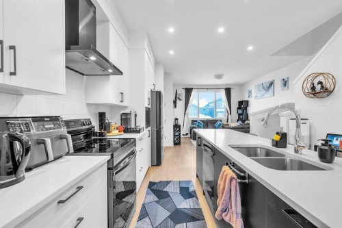 52 Edith Gate Nw, Calgary, AB - Indoor Photo Showing Kitchen With Double Sink