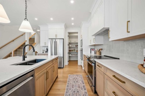 28 Sunvalley View, Cochrane, AB - Indoor Photo Showing Kitchen With Double Sink With Upgraded Kitchen