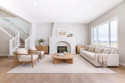 203 Langwell Common Se, Airdrie, AB - Indoor Photo Showing Living Room With Fireplace