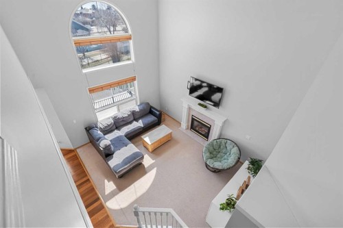 136 Coral Springs Landing Ne, Calgary, AB - Indoor Photo Showing Other Room With Fireplace