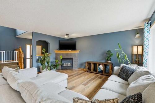 515 Stonegate Road Nw, Airdrie, AB - Indoor Photo Showing Living Room With Fireplace