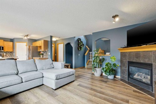 515 Stonegate Road Nw, Airdrie, AB - Indoor Photo Showing Living Room With Fireplace
