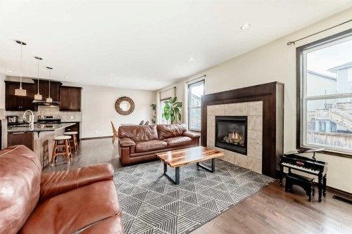 691 Panamount Boulevard Nw, Calgary, AB - Indoor Photo Showing Living Room With Fireplace