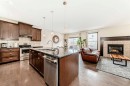 691 Panamount Boulevard Nw, Calgary, AB  - Indoor Photo Showing Kitchen With Fireplace With Stainless Steel Kitchen With Upgraded Kitchen 