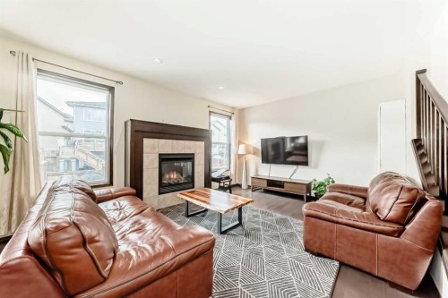 691 Panamount Boulevard Nw, Calgary, AB - Indoor Photo Showing Living Room With Fireplace