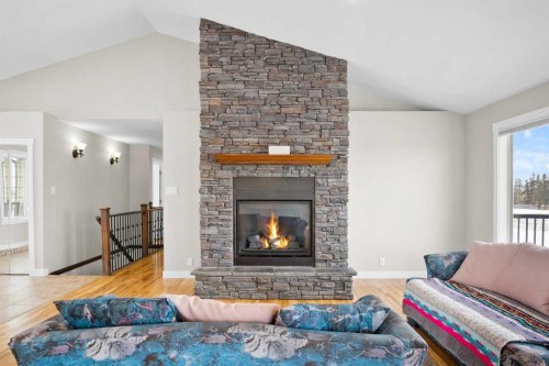 31017 Range Road 23, Rural Mountain View County, AB - Indoor Photo Showing Living Room With Fireplace