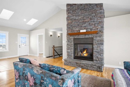 31017 Range Road 23, Rural Mountain View County, AB - Indoor Photo Showing Living Room With Fireplace