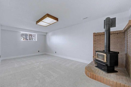 1607 Marlyn Way Ne, Calgary, AB - Indoor Photo Showing Other Room With Fireplace