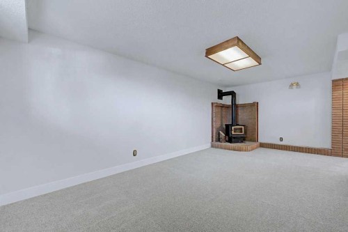 1607 Marlyn Way Ne, Calgary, AB - Indoor Photo Showing Other Room With Fireplace