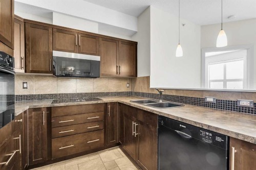 415-26 Val Gardena View Sw, Calgary, AB - Indoor Photo Showing Kitchen With Double Sink