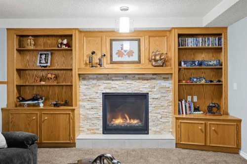 1331 Sunvista Way Se, Calgary, AB - Indoor Photo Showing Living Room With Fireplace