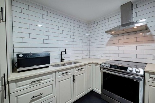 3 Saddlebred Court, Cochrane, AB - Indoor Photo Showing Kitchen With Double Sink