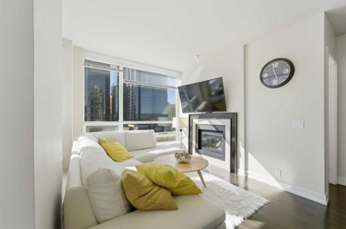 825-222 Riverfront Avenue Sw, Calgary, AB - Indoor Photo Showing Living Room With Fireplace