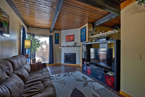 80 Queen Alexandra Close Se, Calgary, AB - Indoor Photo Showing Living Room With Fireplace