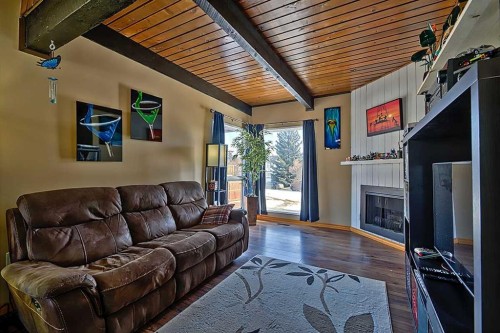 80 Queen Alexandra Close Se, Calgary, AB - Indoor Photo Showing Living Room With Fireplace