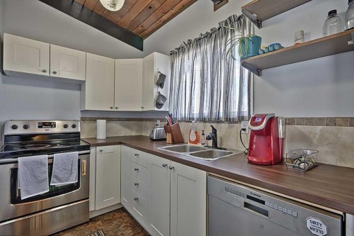 80 Queen Alexandra Close Se, Calgary, AB - Indoor Photo Showing Kitchen With Double Sink