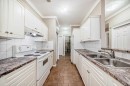 205-7 Lineham Avenue, Okotoks, AB  - Indoor Photo Showing Kitchen With Double Sink 