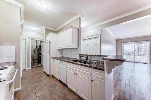 205-7 Lineham Avenue, Okotoks, AB - Indoor Photo Showing Kitchen With Double Sink