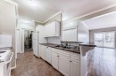 205-7 Lineham Avenue, Okotoks, AB  - Indoor Photo Showing Kitchen With Double Sink 