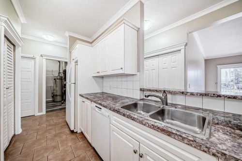 205-7 Lineham Avenue, Okotoks, AB - Indoor Photo Showing Kitchen With Double Sink