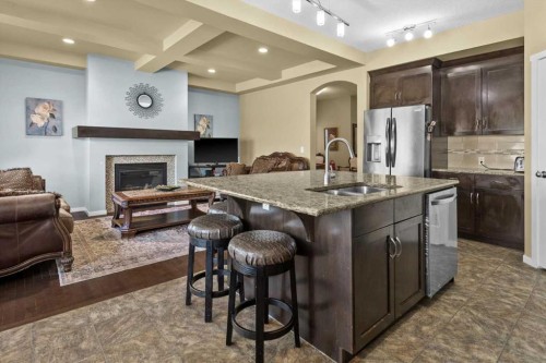 15 Sage Berry Road Nw, Calgary, AB - Indoor Photo Showing Kitchen With Fireplace With Double Sink With Upgraded Kitchen