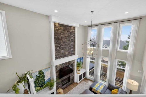 105 Westpoint Way Sw, Calgary, AB - Indoor Photo Showing Other Room With Fireplace