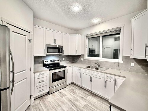 189 Carringvue Way Nw, Calgary, AB - Indoor Photo Showing Kitchen With Double Sink With Upgraded Kitchen
