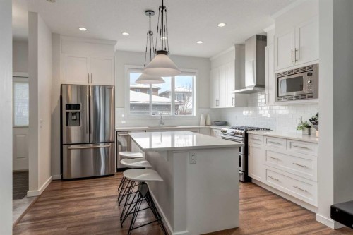 128 Heritage Heights, Cochrane, AB - Indoor Photo Showing Kitchen With Stainless Steel Kitchen With Upgraded Kitchen