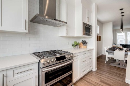 128 Heritage Heights, Cochrane, AB - Indoor Photo Showing Kitchen With Stainless Steel Kitchen With Upgraded Kitchen