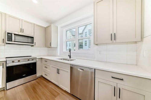 86 Heirloom Passage Se, Calgary, AB - Indoor Photo Showing Kitchen With Double Sink