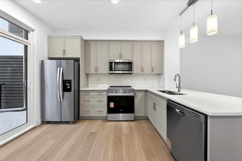90 Heirloom Passage Se, Calgary, AB - Indoor Photo Showing Kitchen With Double Sink