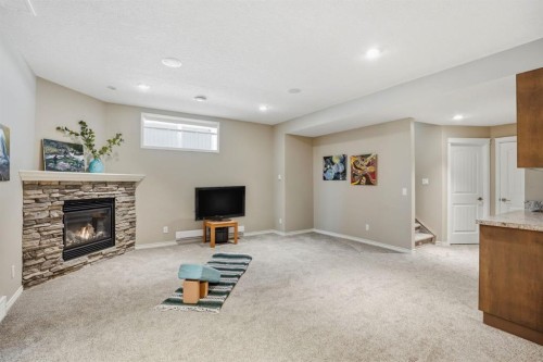 138 Reunion Landing, Airdrie, AB - Indoor Photo Showing Basement With Fireplace