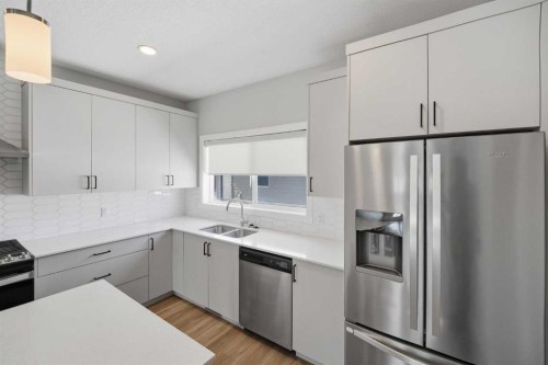 125 Edith Gate Nw, Calgary, AB - Indoor Photo Showing Kitchen With Stainless Steel Kitchen With Double Sink With Upgraded Kitchen