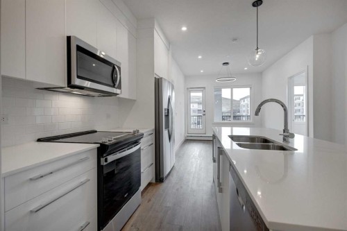 4304-111 Wolf Creek Drive Se, Calgary, AB - Indoor Photo Showing Kitchen With Stainless Steel Kitchen With Double Sink With Upgraded Kitchen