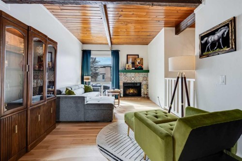 120 Oaktree Lane Sw, Calgary, AB - Indoor Photo Showing Living Room With Fireplace