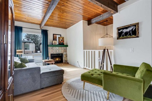 120 Oaktree Lane Sw, Calgary, AB - Indoor Photo Showing Living Room With Fireplace