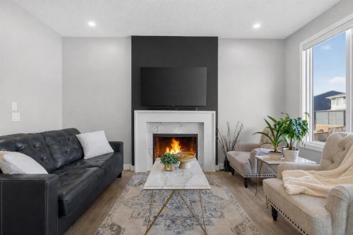96 Emberside Glen, Cochrane, AB - Indoor Photo Showing Living Room With Fireplace