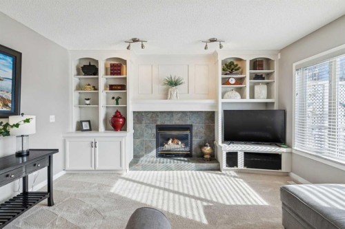 420 Rocky Ridge Bay Nw, Calgary, AB - Indoor Photo Showing Living Room With Fireplace