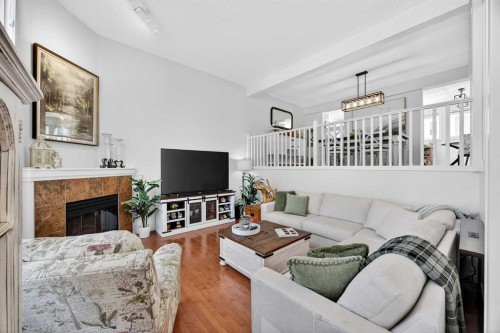 94 Candle Terrace Sw, Calgary, AB - Indoor Photo Showing Living Room With Fireplace