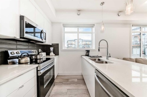 3112-410 Seton Passage Se, Calgary, AB - Indoor Photo Showing Kitchen With Double Sink With Upgraded Kitchen