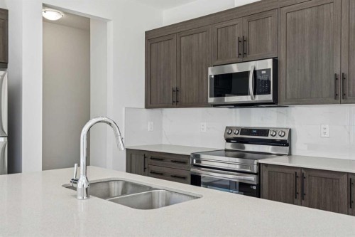 25 Yorkstone Row Sw, Calgary, AB - Indoor Photo Showing Kitchen With Stainless Steel Kitchen With Double Sink With Upgraded Kitchen